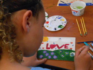 Girl at TES paint LOVE