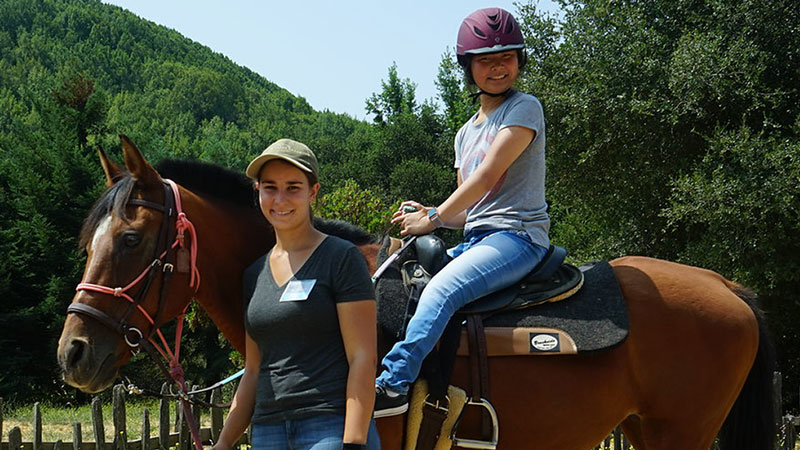 Ruby Shemaria riding a horse at Halleck Creek Ranch